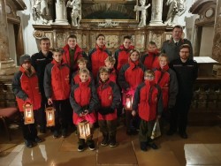 Jugendmitglieder aus dem Bezirk Gmunden und ihre Betreuer bei der Übernahme des Friedenslichts aus Bethlehem in der Stiftskirche St. Florian